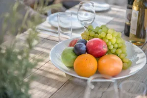 Welcome fruit and wine laid out on Villa Levanda's outdoor dining table