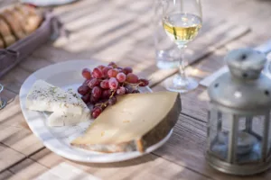 Cretan cheese, grapes and local wine on the terrace table at Bleverde