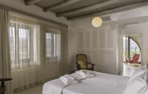 Bedroom at Villa Levanda with louvred wardrobes and doors onto a terrace