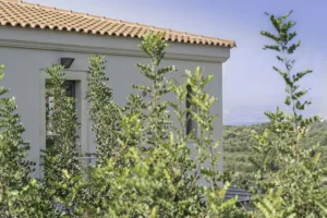 Villa Levanda's exterior, with the bay visible through the surrounding trees