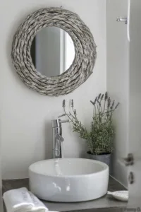 Washbasin with a driftwood mirror and lavender in a Villa Levanda bathroom