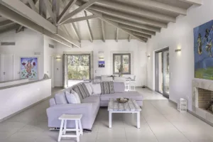 Villa Levanda's living room with a corner sofa, fireplace and contemporary art